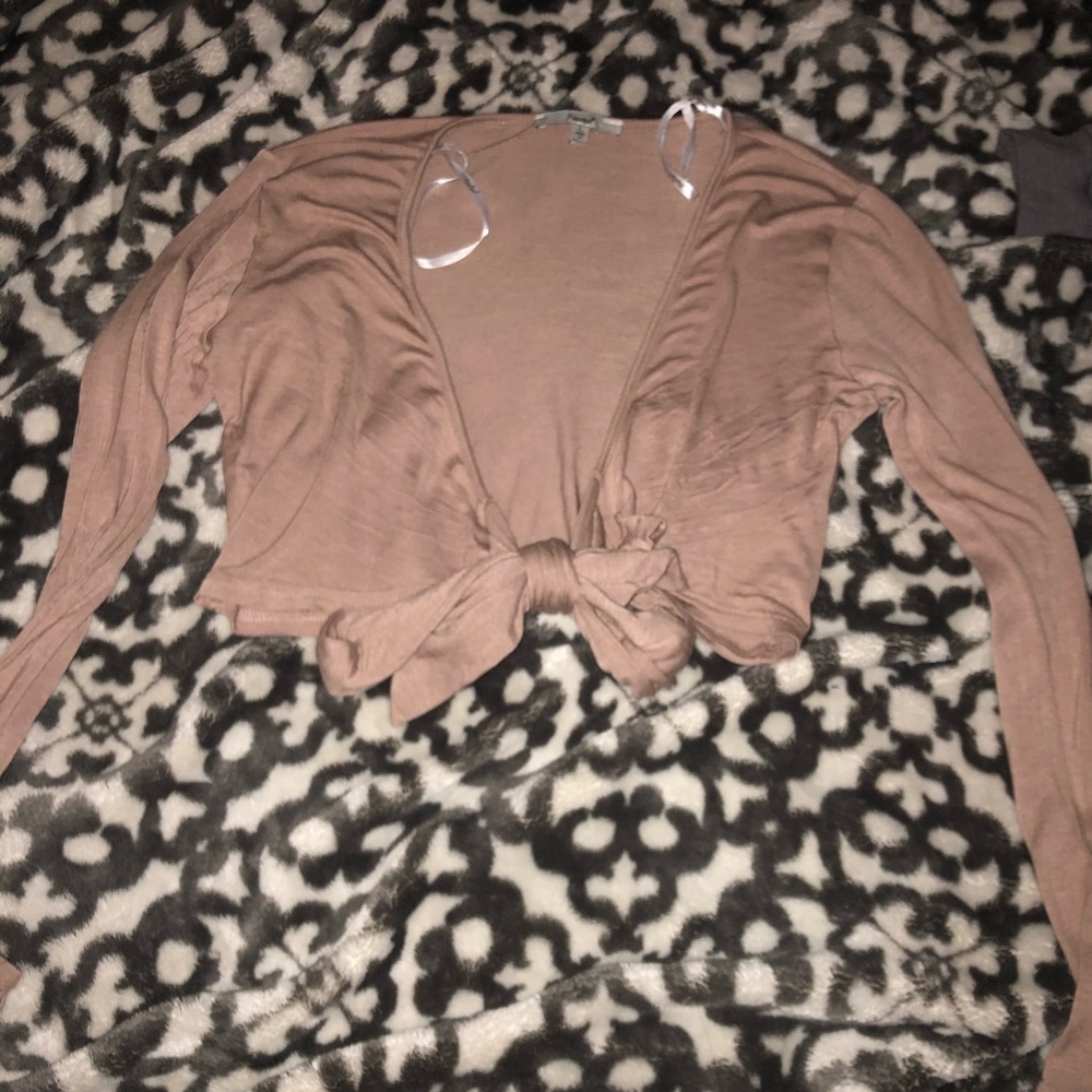 This is a large tan crop top cover up.